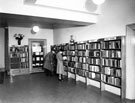 Two adults at the shelves in front of the display case, Ecclesall Library (former Weetwood House), Knowle Lane Two adults at the shelves in front of the display case, Ecclesall Library (former Weetwood House), Knowle Lane