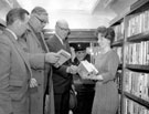 Interior of the first Sheffield Libraries Mobile Service, L. to R.  (?), Alderman Sidney Dyson, Chair of Transport Committee, John Thorpe, Chair of Libraries, Art Galleries and Museums, driver and librarian