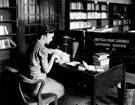 Central Library, Surrey Street. Book Stocks and Cataloguing Department, Miss Dawes packing an Extension Service Box