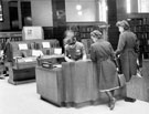 Miss Bowers at Enquiry Desk, view from M-Z charge, Central Lending Department, Central Library, Surrey Street