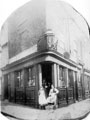Commercial Hotel, landlord John Jones, No 34, Button Lane and junction of Carver Street with Ginni Jones and unknown barman outside. Building on right has 'Moorhead Fish Restaurant' sign
