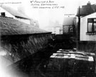 Yard belonging to William Proctor and Sons, slate merchants, Nos. 52 and 54 Denby Street (formerly New Thomas Street). Side gable of No 47, Sheldon Street, left. Rear of No 48, Arley Street and Cricketers Inn, John Street,  in background