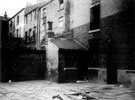Court No. 8, Trafalgar Street, showing rear of back to back houses, Court No. 3, Trafalgar Lane, over the wall