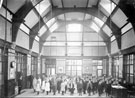 Interior of  Hammerton Street School, Darnall showing children and teachers with the inscription on the back wall, Let knowledge grow from more to more