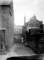 Unidentified alley of unidentified road, house No. 49 on left. Information with photograph reads back of Sunderland
