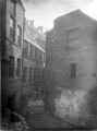 Rear of Imperial Hotel stockrooms, Water Lane, left,. Rear of W. Fox and Sons, chemists, right