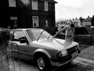 Resident of the Parson Cross Estate cleaning a car