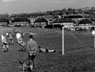 Football in Parson Cross Park with housing on Deerlands Avenue and  St. Peter's  R.C. School (right) in the background