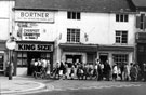 Queueing for cheap cigarettes outside No. 31, King Size Cheap Cigarette Shop former premises of Alex Henry Bortner, jeweller; No. 33, Sally's Tea and Coffee Shop and 35, Sally's Pantry, Orchard Street from Leopold Street Queueing for cheap cigarettes outside No. 31, King Size Cheap Cigarette Shop former premises of Alex Henry Bortner, jeweller; No. 33, Sally's Tea and Coffee Shop and 35, Sally's Pantry, Orchard Street from Leopold Street