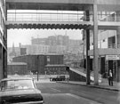 Looking towards Wharf Street Goods Depot from Castle Market, with St John's Church far left,  Hyde Park Flats being constructed in the background and the smaller Bernard Street flats centre right.