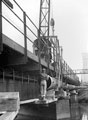 Positioning Sewer Pipes underneath a railway bridge over the River Don, (the line ran from Tinsley junction to Tinsley Junction West) with one of the Cooling Towers in the background, Tinsley Sewerage Scheme