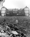 Child playing among the dereliction in an unidentified area Child playing among the dereliction in an unidentified area