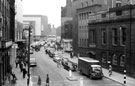 Elevated view of evening traffic in Castle Street with the Court House, formely the old Town Hall  (right); Arthur Davy and Son Ltd., provision merchants and Cannon Hotel (left)
