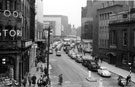 Elevated view of evening traffic in Castle Street with the Court House, formely the old Town Hall  (right); Arthur Davy and Son Ltd., provision merchants and Cannon Hotel (left)