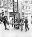 Drilling with a wheeled escape ladder in Division Street Fire Station yard, early 1960s