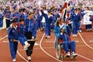 Great Britain Team Captain, javelin thrower Steve Backley assists an injured fellow Team Member at the Closing  Ceremony, World Student Games, Don Valley Stadium