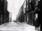 Button Lane looking towards junction with Carver Street. Premises on right include Nos. 18 - 22 Angel Inn (with arch). Rear of George Binns Ltd., tailors, left, fronting The Moor