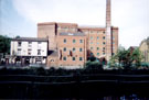 Looking across the River Don to Manchester Hotel (No. 108 Nursery Street) and Aizlewoods Mill (formerly the Crown Corn Mill of John Aizelwood Ltd.), Nursery Street from Riverside Walk over the River Don to Nursery Street