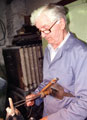 Stan Shaw (1927 - 2021) using a parser to cut shields (nameplates) in pocket-knife handles at his workshop, Garden Street