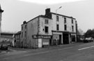 Broad Street looking towards (left) Blast Lane showing (l. to r.) M. J. News; 59 - 61 and the site of the demolished Old Blue Ball public house sign frame only remaining at the junction with Broad Street with the Supertram Viaduct in the background