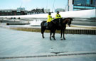 Mounted police and horses Aston (left) and Sandbeck (right) by the fountain and Cutting Edge Sculpture, Sheffield Midland railway station