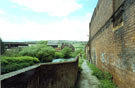 River Don near Brightside Weir from Weir Head, Five Weirs Walk looking towards Wincobank Hill with remnents of Brightside Works wall right