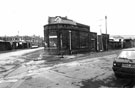 Junction of Burton Road (left) and Hicks Street showing the roof and wall of A2B Taxis (originally Neepsend Police Station)