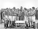Sally (Isabel) Mummery wife of Wing Commander Ken A. Mummery presenting the Cup to R.A.F. Norton Rugby Team 1957