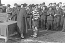 Sally (Isabel) Mummery wife of Wing Commander Ken A. Mummery presenting medals to R.A.F. Norton Rugby Team 1950's