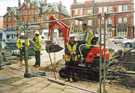 Cleaning up in The Wicker after the flood during major roadworks and refurbishments