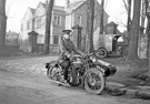 Pc No 301 J A Lloyd on his motorbike (Reg. No. WJ 677) outside the new Crosspool Tavern (Manchester Road), that was built on the site of the Lodge for Lydgate Hall showing the gateposts