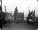 High Street looking towards Commercial Street showing decorations for the royal visit of Queen Victoria. Fitzalan Square, right, Birmingham District and Counties Banking Co. Ltd., centre