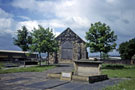 Memorial to Benjamin Huntsman, inventor of Crucible Steel 1704-1776, Hill Top Burial Ground, Attercliffe Common with Attercliffe Chapel of Ease in the background