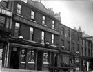 View: y00277 Furnival Road, including Nos. 11 - 13 Alexandra Hotel, Nos. 17 - 21, Albert Taylor's Dining Rooms (extreme right), c.1913 - 1914