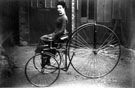 Miss Clara Hayball, (Mrs. Keeling), on a velocipede, taken by her father, Arthur Hayball at his wood-carving works on Cavendish Street (Nos 9, 11 and 13)