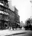 View: y00668 Castle Street on Coronation Day, (premises include, left to right), No. 3 Jones' Sewing Machine Co. Ltd., sewing machine manufacturers, Nos. 5 and 7 William Hy. Naylor, confectioner, Nos. 13 - 15 Waverley Temperance Hotel