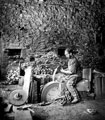 Cutlery manufacture. Grindstone dressing at Ibbotson Wheel, he is using a 'hacking' hammer to level and revive a fresh surface