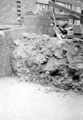 Sheffield Castle excavations recorded by J.B. Himsworth. Newly concreted excavation, burying the plinth of tower and several courses of masonry 	