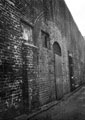 Sheffield Castle excavations recorded by J.B. Himsworth. Brick wall on Chandlers Row, about 30 feet high from the ground to the Castle level above. Largely a retaining wall and basements backing onto the original Castle wall