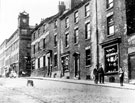 View: y01384 Nos. 17 - 23 Howard Street. Premises include No. 17 W. Wilkinson and Co., patent medicine vendors, Nos. 19 - 23 Douglas C. Marshall, tea merchant. Walker and Hall, Electro Works, silversmiths, in background