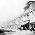 View: y01502 South Street, Moor, premises on right include No. 79 Pump Tavern, Nos. 83 - 85 Thompson and Sons, cycle merchants (with adverts)
