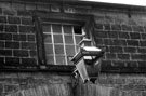Window dated 1825 and old gas lamp over the stable block doors at Barnes Hall, off Elliott Lane, Chapeltown