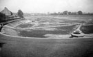 Removing silt from the bottom of an empty Hadfield Dam, Crookes, prior to covering it with a concrete roof