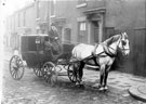 View: y02581 Horse drawn carriage belonging to Joseph Tomlinson and Sons Ltd. on an unidentified street
