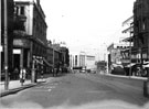 High Street looking towards Blitz damaged Montague Burton Ltd., tailors, showing Sheffield Telegraph and Star Ltd., Kemsley House (left)