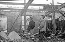Mr. Wild and Mr. Milne survey the damage after the fire at Mellowes and Co. Ltd., metal window manufacturer, Bridge Street 