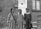 Three young Asian girls outside J. L. Hangas, dental surgery, No. 225 Barnsley Road