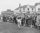 Spectators cheering winner wearing No. 2 Keith French, Hallamshire Harrier in the Sheffield Star Walk with Sportsman's Group, No. 851 Penistone Road in the background Spectators cheering winner wearing No. 2 Keith French, Hallamshire Harrier in the Sheffield Star Walk with Sportsman's Group, No. 851 Penistone Road in the background
