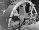 View: s27935 Fly Wheel in comparison to Adult, British Steel Corporation River Don Works 12000 horse power Steam Engine in use to drive a heavy plate mill built by Davy Brothers of Sheffield
