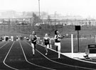 Hallamshire Harriers AC and  (No. 4) and Sale Harriers AC (no. 212) at the finish line, possibly Northern Womens League, Woodbourn Road Athletics Stadium